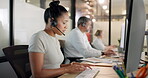 Customer service, call center and black woman typing on computer at night. Contact us, crm telemarketing and group of employees, sales agents or consultants on pc working late in company workplace.