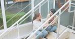 Friends, women sitting on stairs at apartment building and talking, sharing advice and support in life crisis. Trust, help and sad woman with friend on steps having a talk about problem outside home.
