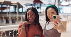 Friends, selfie and women in mall with smile, happiness and funny face with phone for social media. Influencer woman, diversity and smartphone in shopping mall with coffee, digital picture and social