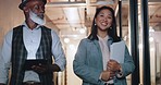 Business people, ceo with employee discussion and walking, senior black man with Asian woman, folder and tablet. Executive, worker and planning, talk in business meeting with partnership in workplace