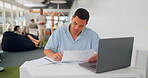 Office documents, laptop and man writing feedback review of business savings, budget or finance portfolio. Accounting, administration and startup accountant working on financial research paperwork