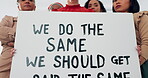 Face, poster and equal pay with a business woman team holding a sign in their office at work for equality. Payment, protest and serious with a female employee group standing to fight for their rights