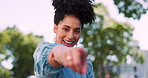 Face, fun and gesture with a black woman pointing while standing outdoor and laughing or joking. Laugh, humor and joke with a female outside in the park gesturing I see you with a hand sign