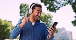 Asian man dance, headphone and smartphone for music, outdoor and casual. Male, guy and headset to listen to radio, relax and wellness for balance, streaming and online song for celebration and energy