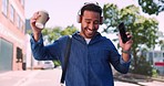 Dance, phone music and man walking in urban city street, listening to radio song or celebrate happy news. Crazy fun energy, headphones and person excited, dancing celebration or streaming audio sound