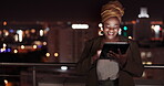 Tablet, night and balcony with a business black woman doing research online while standing outdoor at her office. Working late, search and deadlines with a female employee doing overtime at work