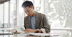 Businessman, writing report and documents with business plan proposal in conference room and company strategy in Japan. Employee focus, Asian man working with notes and pen, development and growth.