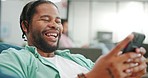 Laugh, happy and mobile text of a black man typing on social media communication app. Laughing, internet scroll and web meme of a man online on a mobile phone texting and reading a funny joke