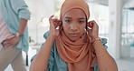 Face, muslim and working with a business woman adjusting her hijab while sitting in the office for work. Hands, head or empowerment with an islamic female employee moving her headscarf in a workplace