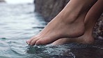 Feet of woman, dip in ocean or sea on vacation, trip or summer holiday. Relax, paradise and barefoot girl relaxing with foot in river, lake or body of water for peace, calm and relaxation outdoors.
