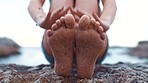 Relax, feet and woman barefoot in sand or dirt while enjoying beach holiday travel with outdoor close up. Summer, ocean and vacation getaway and fun at seaside with playful hands touching toes