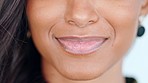 Mouth, lips and teeth of smiling woman with white smile and dark, perfect and clear skin. Closeup face detail of a happy laughing and cheerful female after whitening treatment at dentistSmiling, beautiful and fresh female face winking feeling fun, silly a