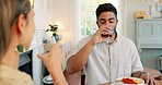 Toast, love and couple on a wine date in a house in celebration of a happy marriage and anniversary. Smile, romance and young woman drinking alcohol and eating spaghetti food with a romantic partner
