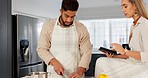 Couple, digital tablet and cooking with online recipe on the kitchen. Young man cutting vegetables and woman reading instructions on the internet, web or food website. while preparing healthy meal