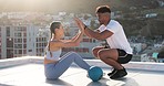 Sit ups, fitness and personal trainer with a woman on a rooftop of a city building training with a medicine ball. Motivation, support and instructor high fives a girl after coaching in an exercise