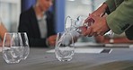 Business staff, hands and pouring water into glass of a employee ready for a meeting. Drink, office workers and conference room table with employee group and strategy documents for discussion