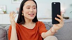 Happy, phone call and woman on video communication talking on smartphone sitting on sofa of home in Singapore. Asian girl, relax on couch and speaking on wifi connection with a smile in apartment