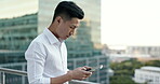 Asian man, city business and phone on rooftop of office building for social networking, mobile app search and reading economy news notification. Worker, balcony and typing on smartphone technology