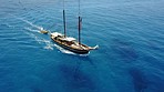 Travel, aerial drone and boat in ocean for cruise, holiday and summer vacation on islands in Mauritius. Sailing, sea landscape and top view of yacht for tropical adventure, freedom and traveling