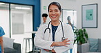 Face, doctor and arms crossed in busy hospital for about us, medical life insurance or wellness support. Smile, happy and healthcare woman in portrait, confidence trust or clinic medicine leadership