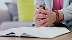 Woman hands, bible and christian prayer in home with book for reading and learning about God. African person pray with hope on living room sofa to worship gospel time for spiritual or faith study