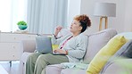 Black woman, laptop and thinking in remote work on living room sofa for business plan or project at home. Thoughtful African American female freelancer on computer wondering and relaxing on couch