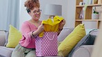 Shopping bag, fashion choice and woman at home looking at retail clothing sale in a living room. Gift, young female and present bags with a person feeling happy about discount and promotion item