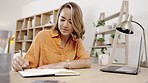 Woman writing, home study and happy person doing research for online college course. Planning, schedule and elearning checklist on a notebook in a house with paper information for data learning