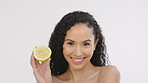 Skincare, woman and lemon fruit portrait for beauty in studio with vitamin c dermatology cosmetic. Aesthetic model person on white background with healthy food for self care, facial and natural glow