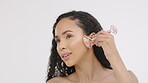 Black woman, face and beauty, facial and roller, natural cosmetics and skincare isolated on studio background. Rose quartz, skin with glow and crystal, spa treatment with self care and cosmetic tools