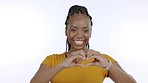 Smile, hands in heart and face of black woman on white background for love, happiness and excited in studio. Emoji shape, reaction and isolated African girl with hand sign for care, support and kind