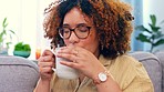 Relax, black woman and coffee on a sofa, happy and smile while thinking, chilling and enjoying the weekend. Tea, cheerful and girl on a couch in living room, peaceful and satisfied, content and calm