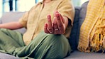 Closeup, hands and woman on sofa, meditation and training for balance, healthy lifestyle and peace. Zoom, female and lady in living room, hand and yoga for pilates training, workout or relax on couch