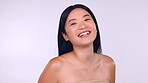Skincare, face and beauty smile of Asian woman in studio isolated on a purple background. Portrait, makeup cosmetics and happy female model laughing with spa facial treatment for healthy skin glow.