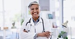 Hospital, smile and face senior doctor with crossed arms for insurance, trust and consulting at clinic. Healthcare, wellness and portrait of happy woman for help, patient service and medical care