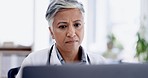 Healthcare, laptop and woman doctor doing research in office in the hospital after consultation. Technology, professional and senior female medical worker analyzing test results in a medicare clinic.