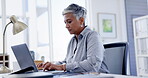 Laptop, documents and proposal with a business woman at work in her office for a review or report. Computer, reading and paperwork with a female employee working on her portfolio for company growth