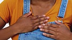 Heart attack, black woman and emergency medical problem with pain from anxiety and stress. Stroke, heartburn and chest rubbing with hands with cardiology issue in a isolated white background studio