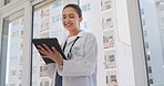 Tablet, happy and woman doctor in the hospital doing medical research on the internet. Happiness, technology and female healthcare worker analyzing test results on a mobile device in medicare clinic.