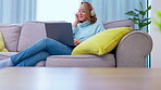 Laptop, headphones and woman listening on couch in work from home balance, relax and mental health smile. Young worker, freelancer or person with music, computer and sofa for creative job inspiration