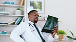 Radiology man or doctor with x ray film, mri results and anatomy analysis thinking of healthcare solution on computer. African professional or medical professional male with human spine xray review