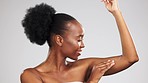 Wellness, body care and black woman in studio with health, beauty and cosmetic routine. Self care, glowing and African model touching skin after hair removal, epilation or shaving by gray background.