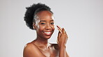 Black woman, face and beauty, skincare and moisturizer, hydration and glow on studio background. Healthy skin, portrait with mockup space, dermatology and cosmetic care with happy female and hands