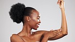 Beauty, body care and black woman in studio with wellness, health and cosmetic routine. Self care, glowing and African model touching skin after hair removal, epilation or shaving by gray background.