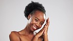 Black woman, face and beauty, skincare and hands, happiness with glow and facial on studio background. Healthy skin, portrait and dermatology with happy female, natural cosmetics and mockup space