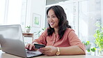 Asian woman, laptop and credit card with smile in ecommerce for online shopping at the office desk. Happy businesswoman typing on computer for internet banking, purchase or transaction at workplace