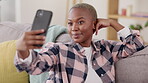 Selfie, tongue and peace with a funny black woman in her home, sitting on a sofa in the living room. Playful, funny and emoji with an attractive young female posing for a profile picture update