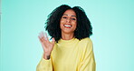 Portrait, wave and greeting with a black woman in studio on a blue background to say hello or welcome. Hand gesture, waving or friendly and an attractive young female saying goodbye with a smile