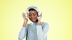 Music, dance and black woman on yellow background with headphones for streaming audio, radio and track in studio. Happy, party mockup and girl dancing for happiness, celebration and positive attitude