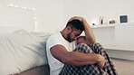 Depression, anxiety and stress with man in bedroom for frustrated, problem and lonely. Grief, sad and mental health issues with guy suffering at home and feeling failure, struggle and burnout